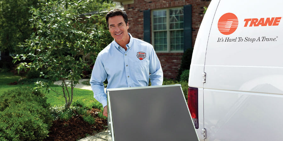 Trane dealer moving new air conditioner into house